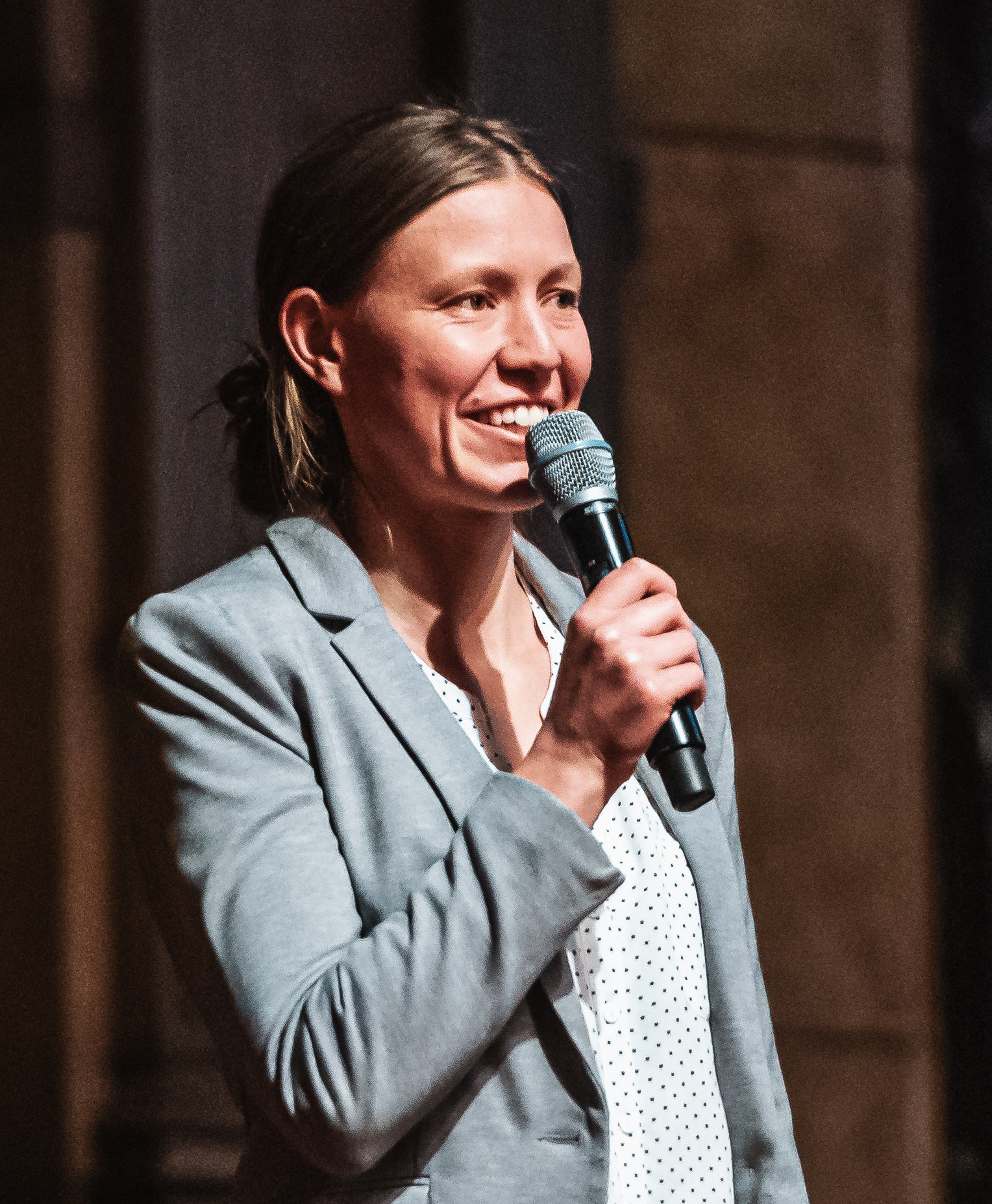 Jana Hasenberg, Moderatorin für Konferenzen und Events, auf der Bühne mit Mikrofon